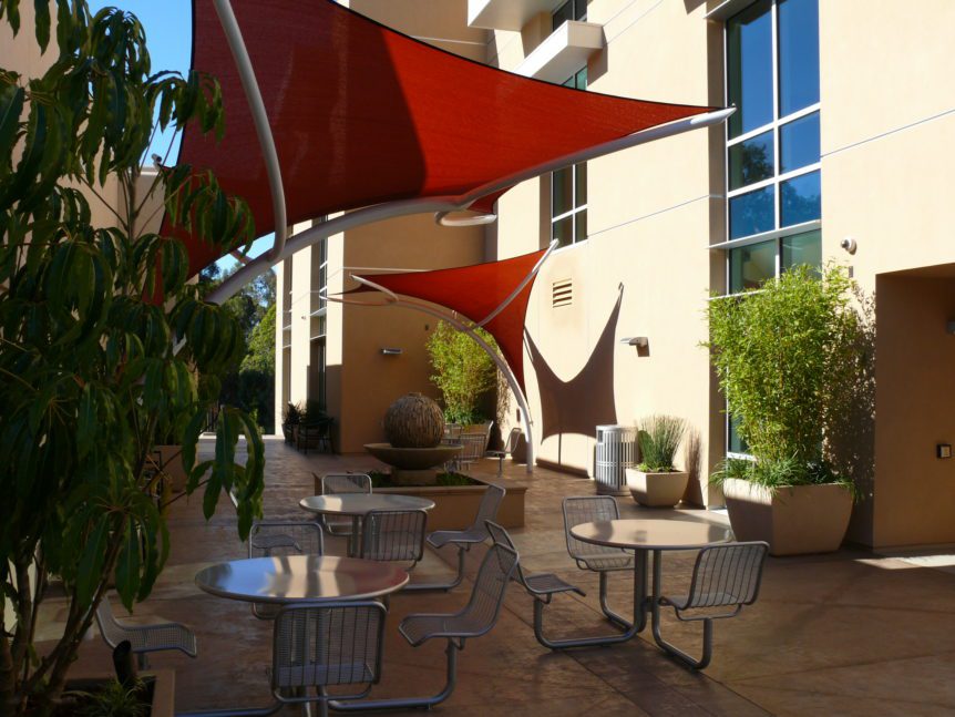 French Hospital Copeland Pavilion - Table seating, water feature, landscape pots and shade sails at upper terrace patio